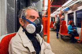 an eldery man with P3R half mask respirator in Prague metro