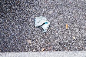 discarded face mask lies on the ground, pandemic, coronavirus, hazardous waste, fag end, cigarette stub