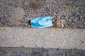 discarded face mask lies on the ground, pandemic, coronavirus, hazardous waste, fag end, cigarette stub