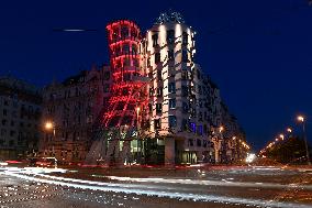 the Dancing House (Fred and Ginger) shines red as part of the Light for AIDS