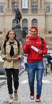People without face masks walk on Wenceslas Square in Prague
