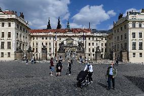 people walk on Hradcany Square in Prague