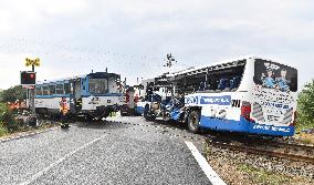 ten injured as train collides with bus at level crossing
