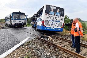 ten injured as train collides with bus at level crossing