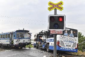 ten injured as train collides with bus at level crossing