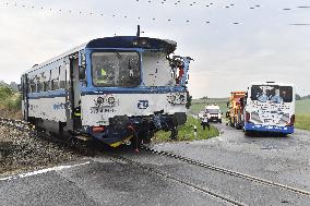 ten injured as train collides with bus at level crossing