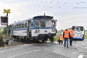 ten injured as train collides with bus at level crossing