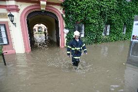 firefighters evacuated the old people's home in Hermanuv Mestec after a nearby pond dam overflowed amid torrential rains