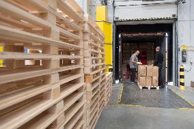 unloading boxes with medical protective equipment in storage facility in Opocinek