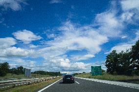 A1 motorway direction to the coastline, highway, low traffic, rideable, almost empty, blue sky, white clouds