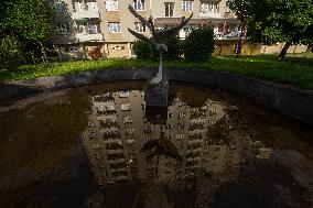 oldest panel building built in Budweis is reflected in a fountain
