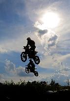 motocross riders compete during the International Championship of the Czech Republic in motocross, silhouette, sun, motocross rider