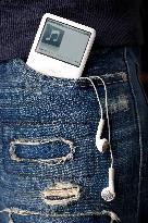 Apple iPod, MP3 player, headphones, jeans, pocket