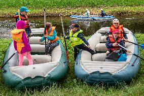 water tourists in a boat on the Orlice river, children