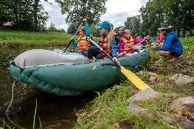 water tourists in a boat on the Orlice river, children