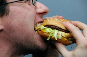 Big Mac hamburger of McDonald's, fast food, mouth