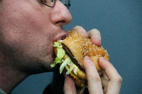 Big Mac hamburger of McDonald's, fast food, mouth