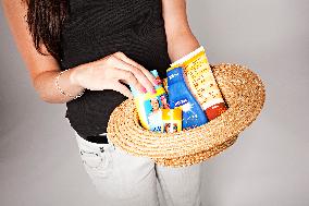 young woman with a hat and sun creams