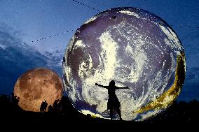 giant inflatable model of the Moon and the planet Earth