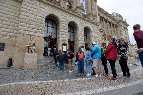 People stand a queue in front of the historical building of National Museum