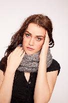 A beautiful young woman, lady, girl, cold, runny nose, headache, scarf