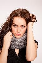 A beautiful young woman, lady, girl, cold, runny nose, headache, scarf