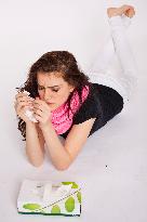 A beautiful young woman, lady, girl, cold, runny nose, headache, tissues, paper hankies, scarf, handkerchiefs, handkerchief, nose-blowing