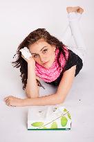 A beautiful young woman, lady, girl, cold, runny nose, headache, tissues, paper hankies, scarf, handkerchiefs, handkerchief, nose-blowing