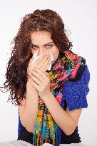 A beautiful young woman, lady, girl, cold, runny nose, headache, tissues, paper hankies, scarf, handkerchiefs, handkerchief, nose-blowing