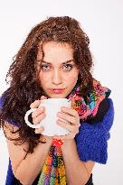 A beautiful young woman, lady, girl, cold, runny nose, headache, cup of tea, scarf, hot drink