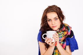 A beautiful young woman, lady, girl, cold, runny nose, headache, cup of tea, scarf, hot drink