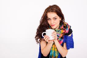 A beautiful young woman, lady, girl, cold, runny nose, headache, cup of tea, scarf, hot drink