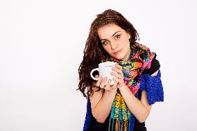 A beautiful young woman, lady, girl, cold, runny nose, headache, cup of tea, scarf, hot drink