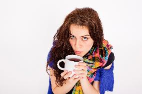 A beautiful young woman, lady, girl, cold, runny nose, headache, cup of tea, scarf, hot drink