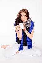 A beautiful young woman, lady, girl, cold, runny nose, headache, cup of tea, scarf, hot drink