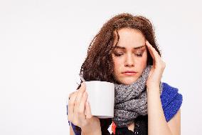 A beautiful young woman, lady, girl, cold, runny nose, headache, cup of tea, scarf, hot drink