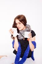 A beautiful young woman, lady, girl, cold, runny nose, headache, tissues, paper hankies, cup of tea, scarf, handkerchiefs, handkerchief, nose-blowing