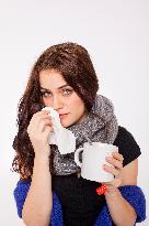 A beautiful young woman, lady, girl, cold, runny nose, headache, tissues, paper hankies, cup of tea, scarf, handkerchiefs, handkerchief, nose-blowing