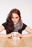 A beautiful young woman, lady, girl, cold, runny nose, headache, cup of tea, scarf, hot drink