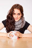 A beautiful young woman, lady, girl, cold, runny nose, headache, cup of tea, scarf, hot drink