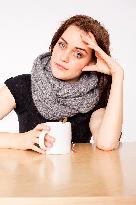 A beautiful young woman, lady, girl, cold, runny nose, headache, cup of tea, scarf, hot drink