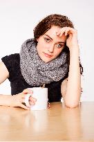 A beautiful young woman, lady, girl, cold, runny nose, headache, cup of tea, scarf, hot drink