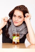 A beautiful young woman, lady, girl,  cold, runny nose, headache, cup of tea with honey, spoon, scarf.