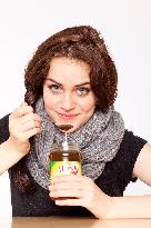 A beautiful young woman, lady, girl, cold, runny nose, headache, tea, honey, spoon, scarf.