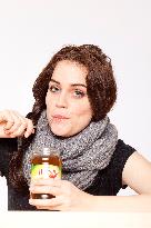 A beautiful young woman, lady, girl, cold, runny nose, headache, tea, honey, spoon, scarf.