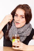 A beautiful young woman, lady, girl, cold, runny nose, headache, tea, honey, spoon, scarf.