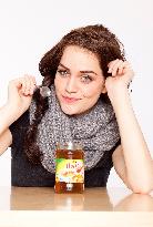 A beautiful young woman, lady, girl, cold, runny nose, headache, tea, honey, spoon, scarf.