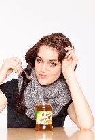 A beautiful young woman, lady, girl, cold, runny nose, headache, tea, honey, spoon, scarf.