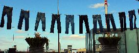 Jeans (blue)  hanging on a rope, clothes pins pegs