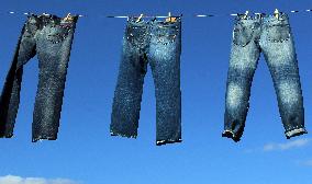 Jeans (blue)  hanging on a rope, clothes pins pegs